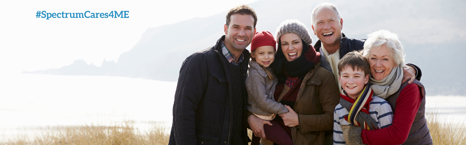 Family walking on beach dunes in early spring